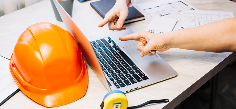 Dos personas frente a computador realizando consulta de dictamen RETIE con la asesoría de RTL Certifications